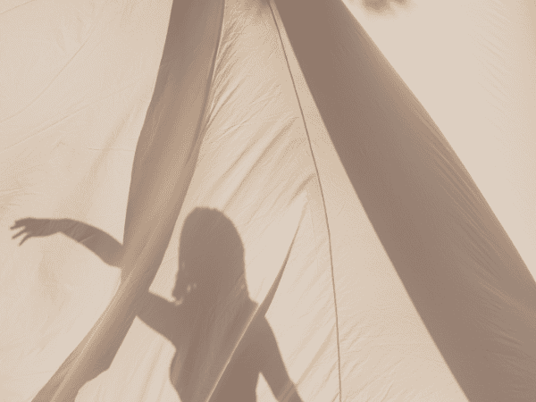 weak sense of self - a shadow of a person on a white tent