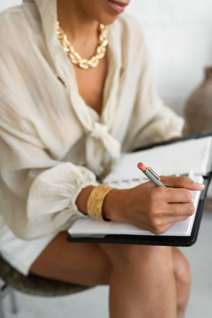 quick self care ideas - a woman writing in a planner
