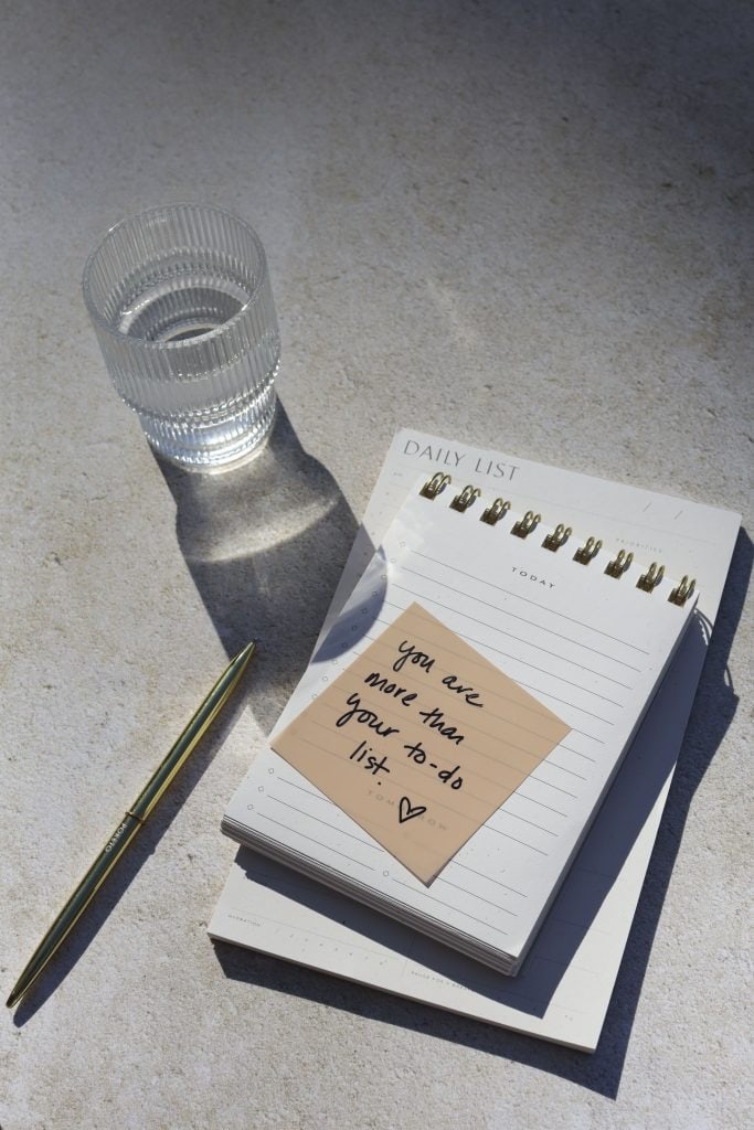 quick self care ideas - glass of water, pen and notepads