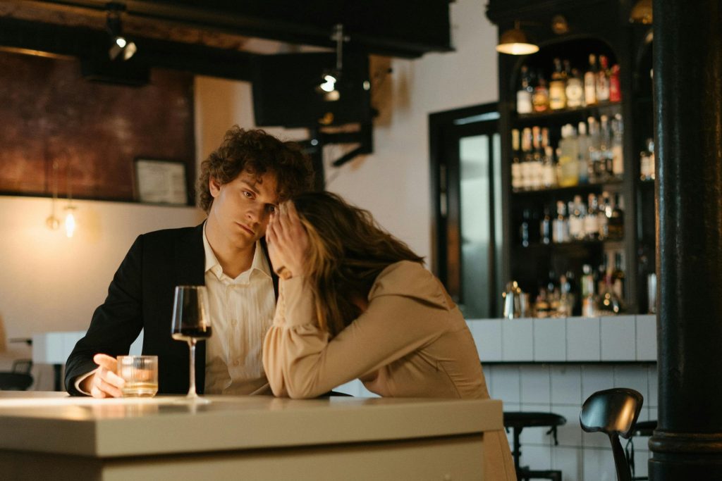 a man and woman looking distressed sitting at a bar with wine glasses - image for anxiety disorders
