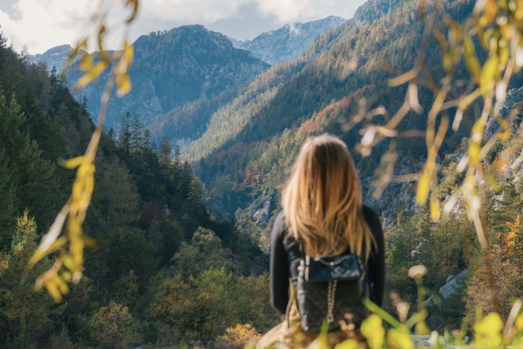 a woman looking out over a mountain valley - how to calm anxiety image